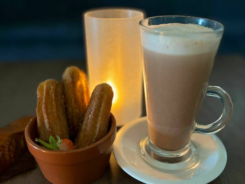 Churros and a hot chocolate on a table, spa in Gloucestershire