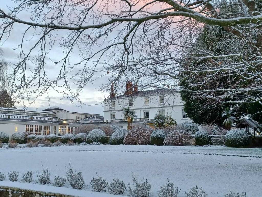 Snowy, frosty frontage of Rowton Hall Hotel