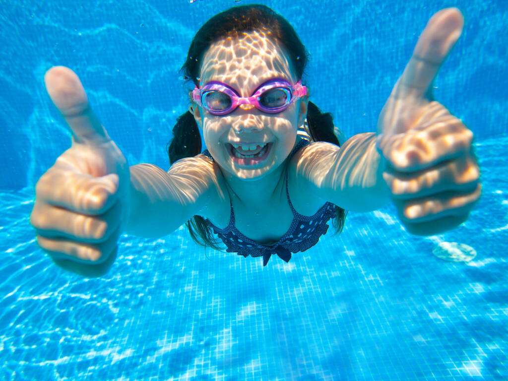 Little girl underwater in swimming pool