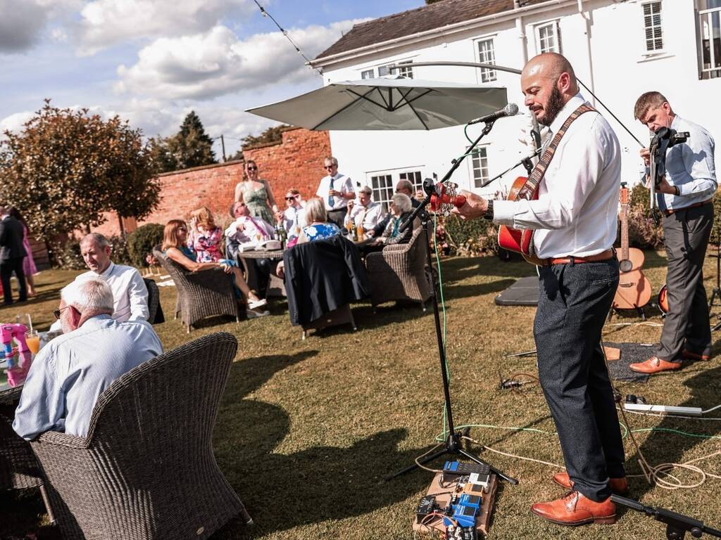 Band play at wedding reception in walled garden