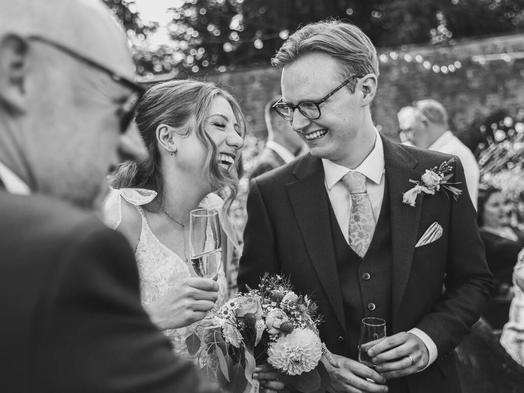 Newly married couple enjoying their drinks reception in the walled garden